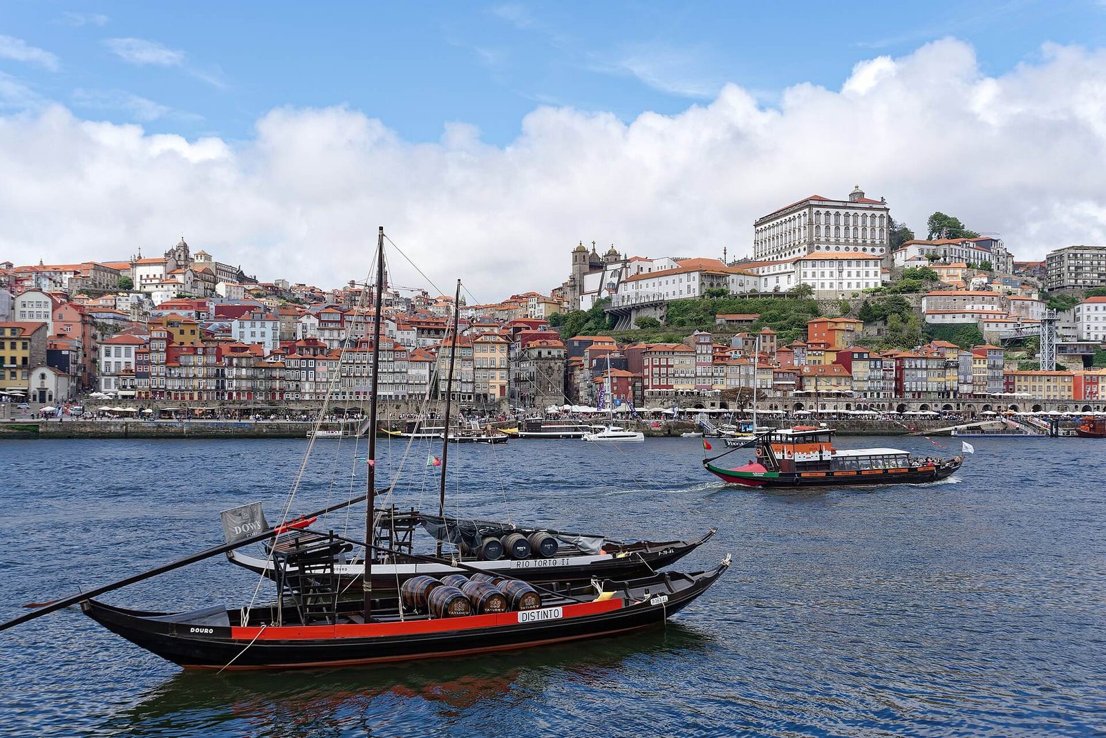 Traditional rabelo boats on the Douro in front of the colourful Ribeira waterfront
