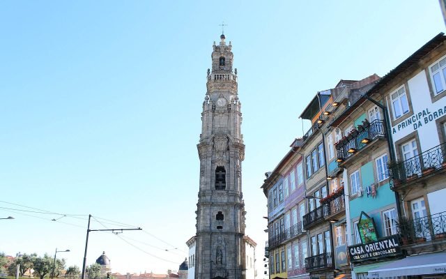 The baroque Clérigos Tower rising above a street of tiled buildings