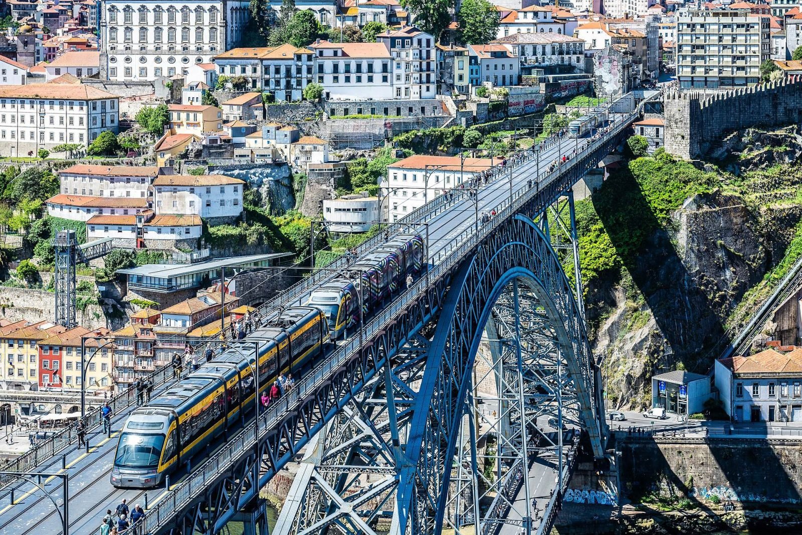 A metro tram crossing the upper deck of the Dom Luís I Bridge above the Douro