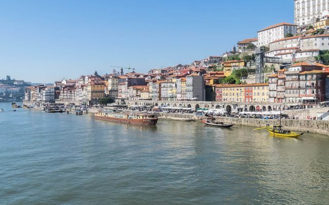 The colourful houses of Ribeira stacked above the Douro, seen from the Dom Luís I Bridge