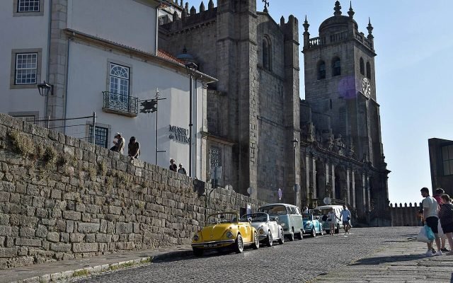 The twin towers of Porto Cathedral above a cobbled street