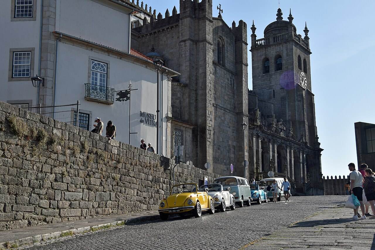The twin towers of Porto Cathedral above a cobbled street