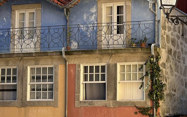 Tall, colourful old houses with wrought-iron balconies in the Ribeira district