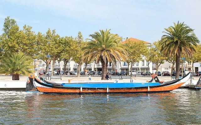 A colourful moliceiro boat on a canal in Aveiro